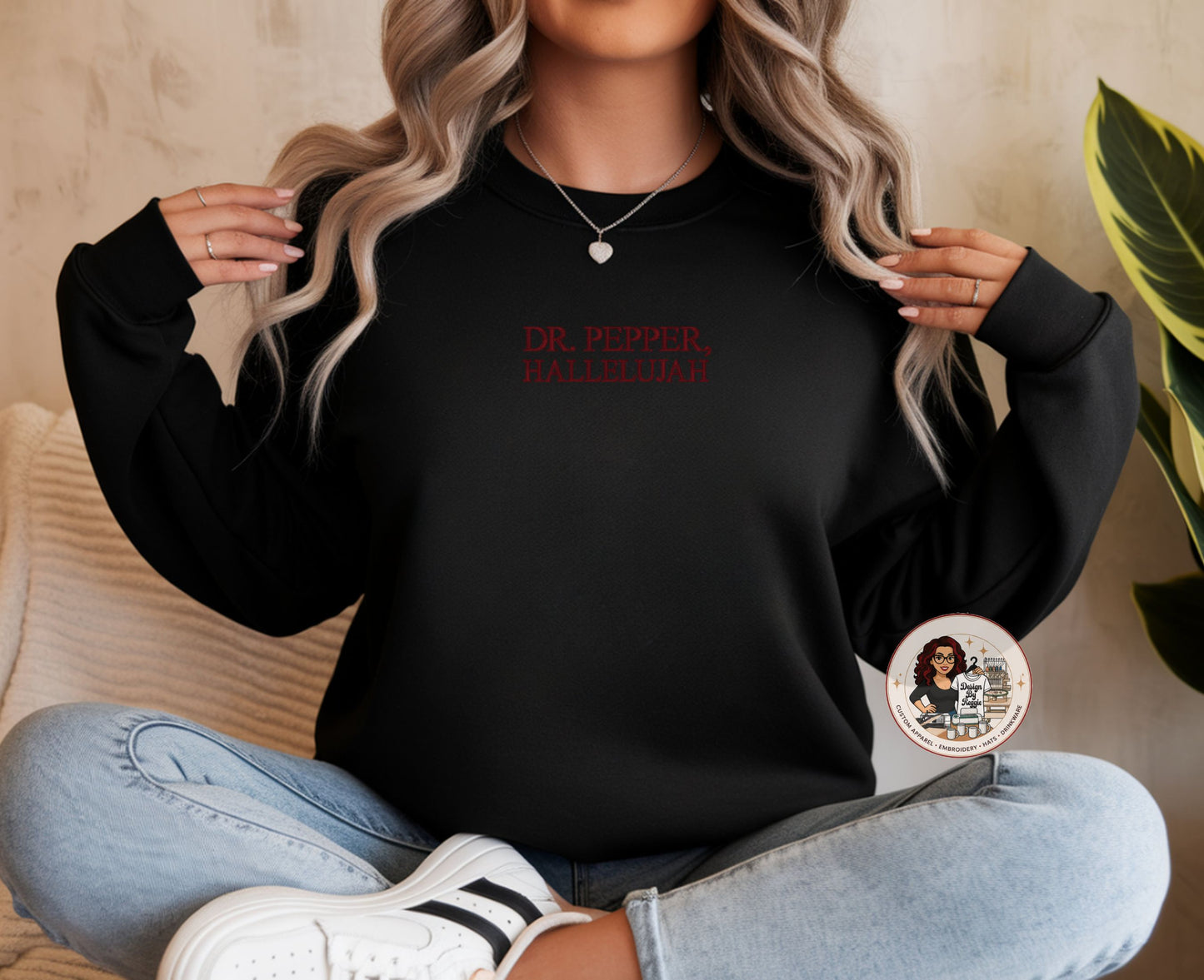Person wearing a black sweatshirt with text, sitting on a couch.