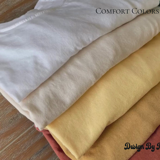 video of colorful t-shirts on wooden table