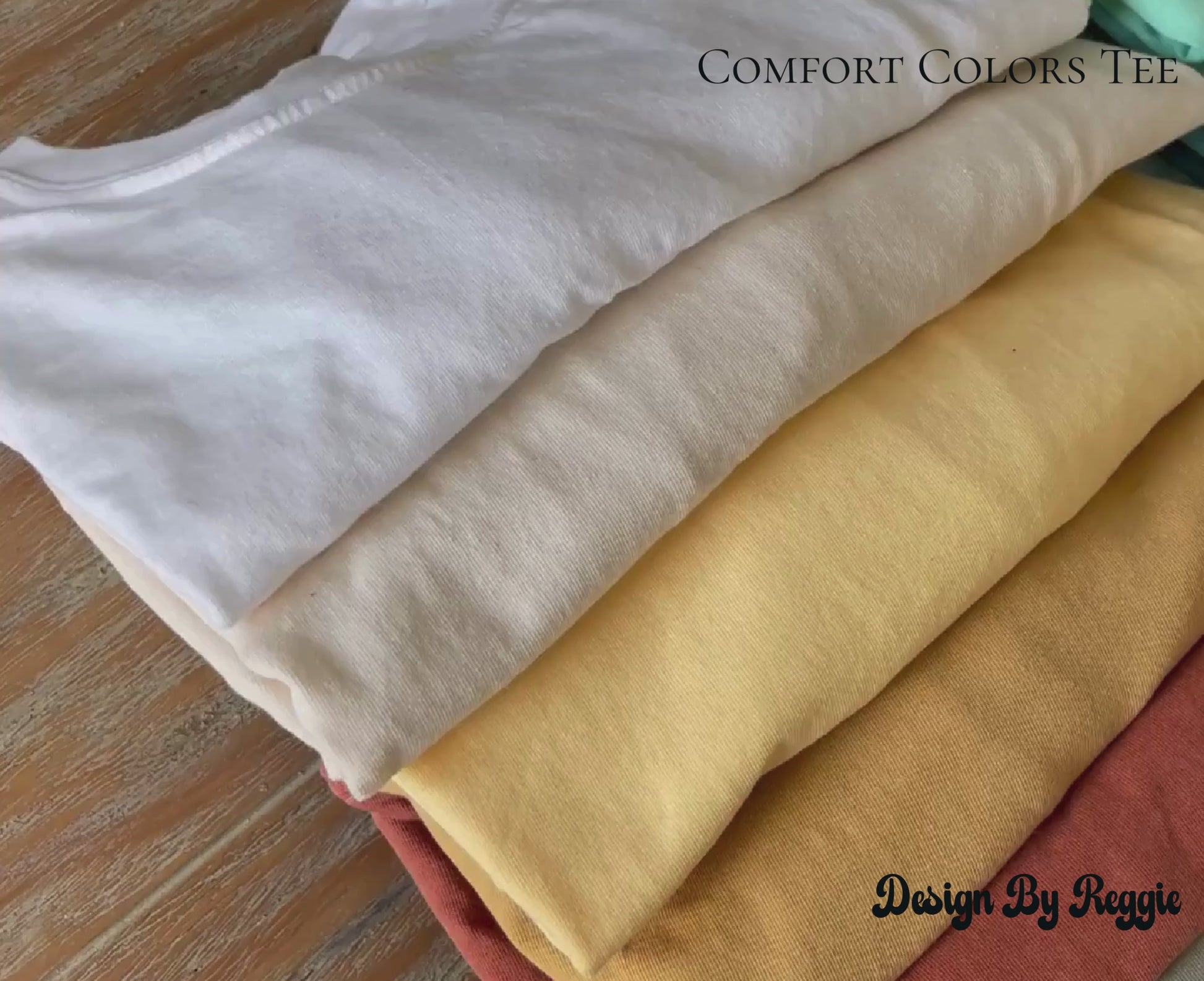video of colorful t-shirts on wooden table